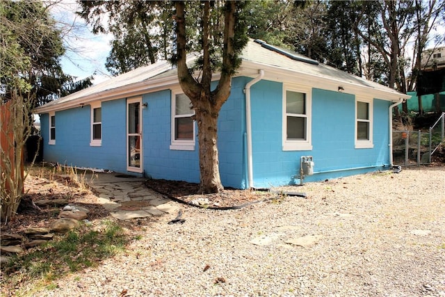 view of front of property with concrete block siding and fence