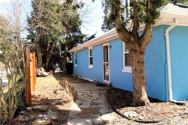 view of property exterior featuring concrete block siding