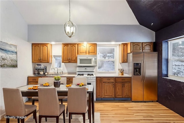 808 Thompson Run Rd, Springdale Twp, PA 15049 - kitchen with white appliances, light wood-type flooring, brown cabinets, and light countertops
