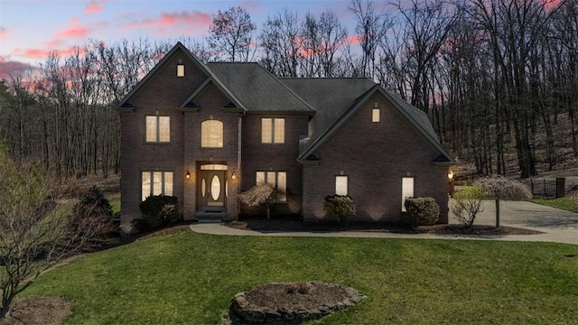 128 Crystal Springs Dr, Cranberry Twp, PA 16066 - traditional-style house with brick siding, a yard, and concrete driveway