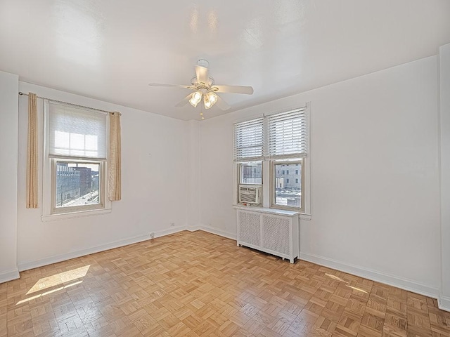 144 N Dithridge St Unit 510, Oakland, PA 15213 - spare room featuring a wealth of natural light, a ceiling fan, radiator, and baseboards