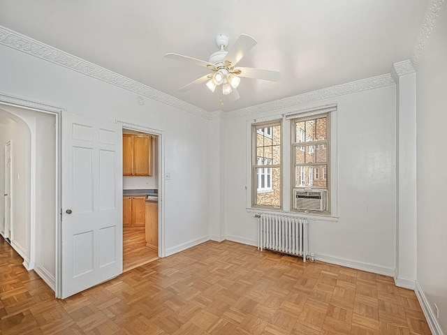 144 N Dithridge St Unit 510, Oakland, PA 15213 - spare room featuring baseboards, arched walkways, a ceiling fan, cooling unit, and radiator heating unit