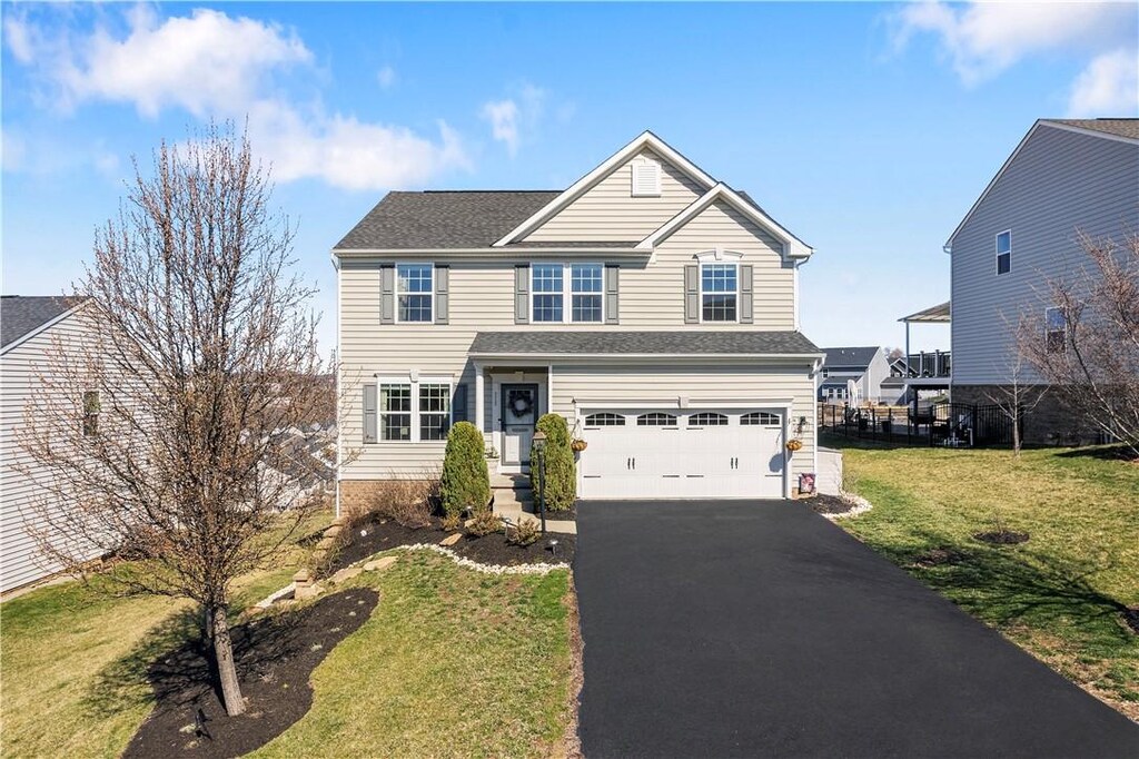 318 Greene Dr, Jefferson Hills, PA 15025 - traditional home featuring a front lawn, driveway, and a garage