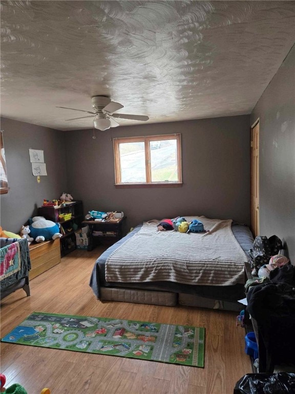104 Forrest St, Petrolia, PA 16050 - bedroom featuring a textured ceiling, ceiling fan, and wood finished floors