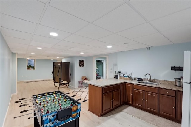 rec room with a sink, light wood finished floors, a paneled ceiling, baseboards, and recessed lighting