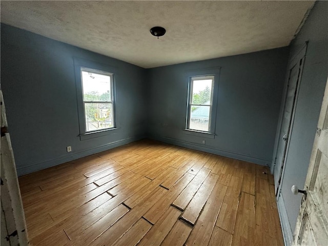 801 Butler Ave, New Castle/4Th, PA 16101 - empty room with hardwood / wood-style floors, plenty of natural light, a textured ceiling, and baseboards