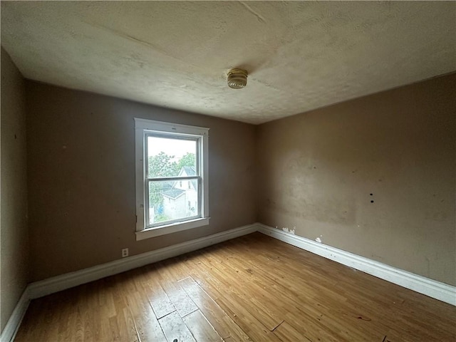 801 Butler Ave, New Castle/4Th, PA 16101 - empty room featuring baseboards, wood-type flooring, and a textured ceiling