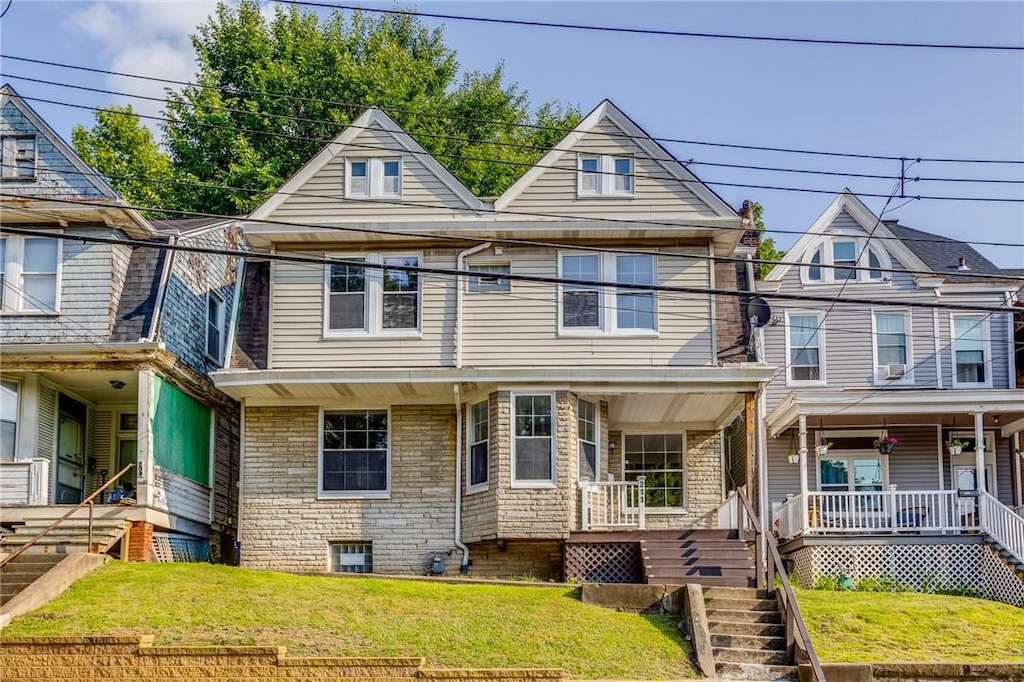 211 W Burgess St, Perry Hilltop, PA 15214 - view of front facade featuring a front lawn, stairs, and covered porch