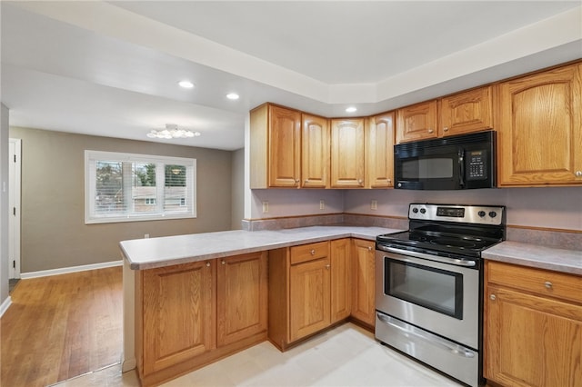 130 Shiela Dr, Green Tree, PA 15220 - kitchen with black microwave, stainless steel range with electric cooktop, a peninsula, recessed lighting, and light countertops