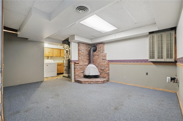 130 Shiela Dr, Green Tree, PA 15220 - unfurnished living room with washer / dryer, a wood stove, carpet, a paneled ceiling, and water heater