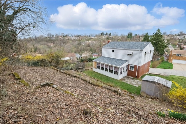 130 Shiela Dr, Green Tree, PA 15220 - rear view of house featuring a shingled roof, brick siding, a sunroom, fence, and a chimney