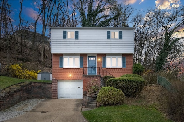 130 Shiela Dr, Green Tree, PA 15220 - view of front of home featuring an attached garage, driveway, and brick siding