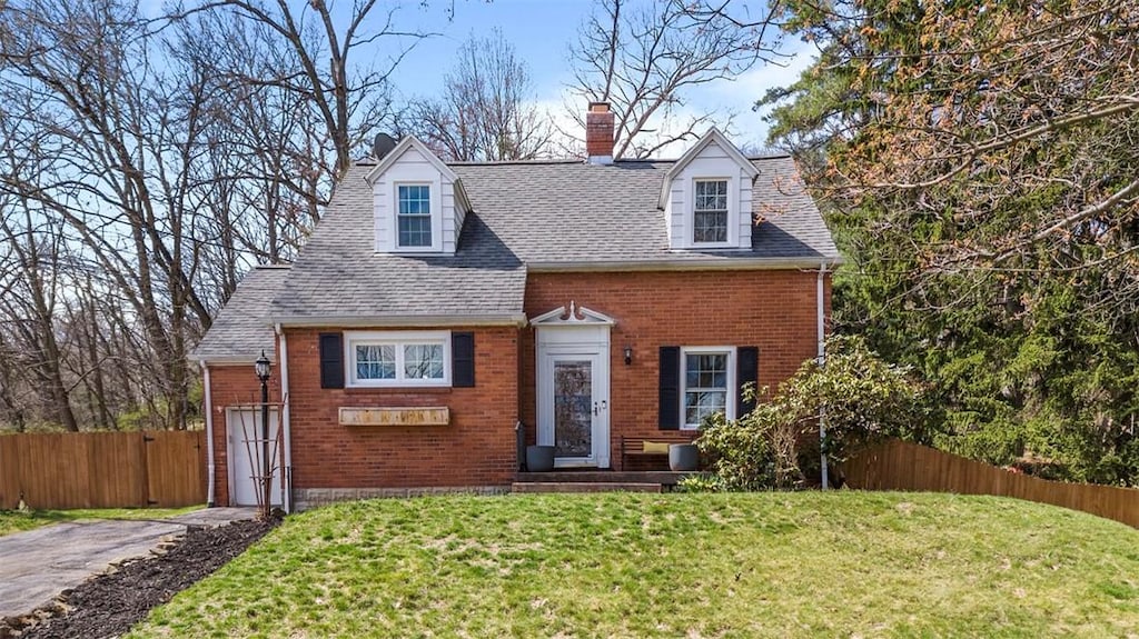 106 Sycamore Dr, Ross Twp, PA 15237 - cape cod house with roof with shingles, brick siding, fence, and a front lawn