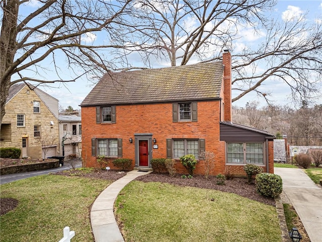 201 Vernon Dr, Mt Lebanon, PA 15228 - colonial house featuring a chimney, a front yard, driveway, and brick siding