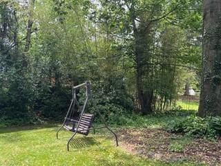 2369 Harrow Rd, Upper St Clair, PA 15241 - view of jungle gym featuring a forest view and a lawn