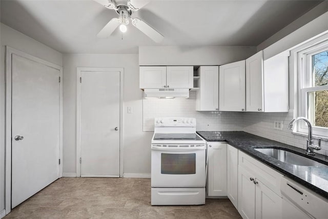 kitchen featuring white appliances, a sink, under cabinet range hood, dark stone counters, and backsplash