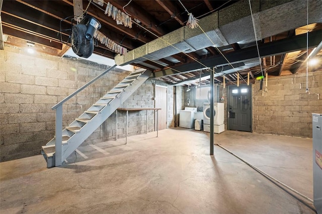 basement featuring independent washer and dryer and stairway