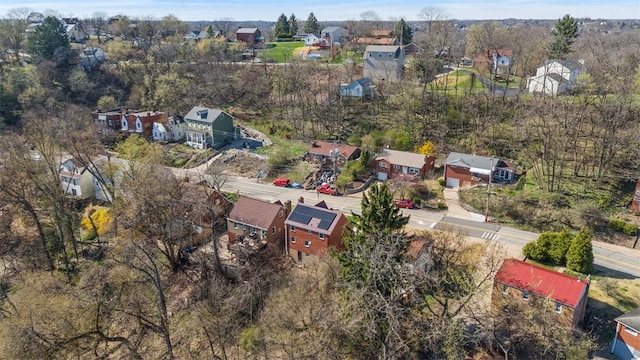 aerial view of property and surrounding area featuring nearby suburban area