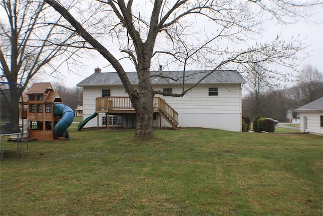 rear view of property featuring a trampoline, a playground, a chimney, a yard, and stairway