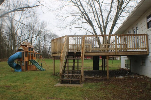view of playground with a lawn and a wooden deck