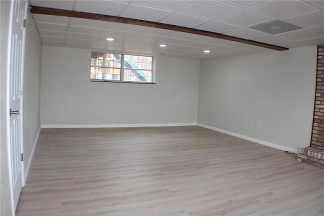 below grade area with light wood-type flooring, recessed lighting, and baseboards