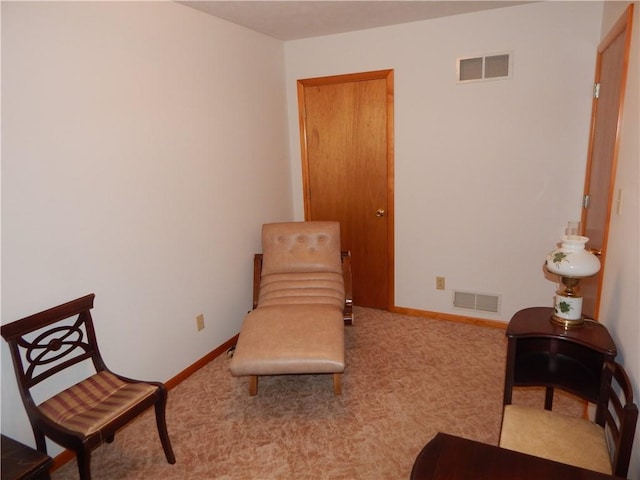 sitting room with baseboards, carpet flooring, and visible vents