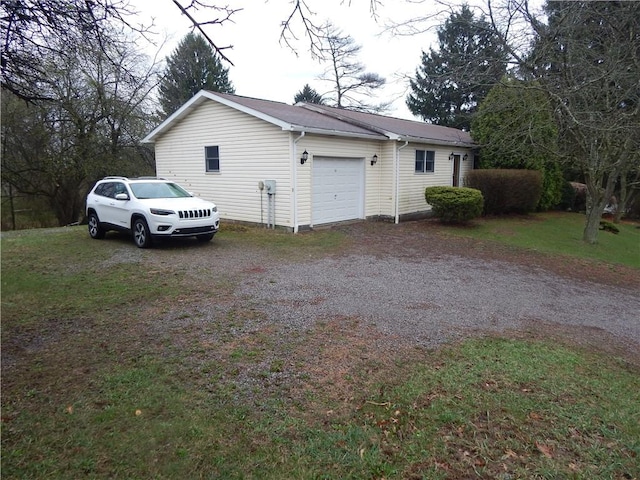 view of property exterior with an attached garage and gravel driveway