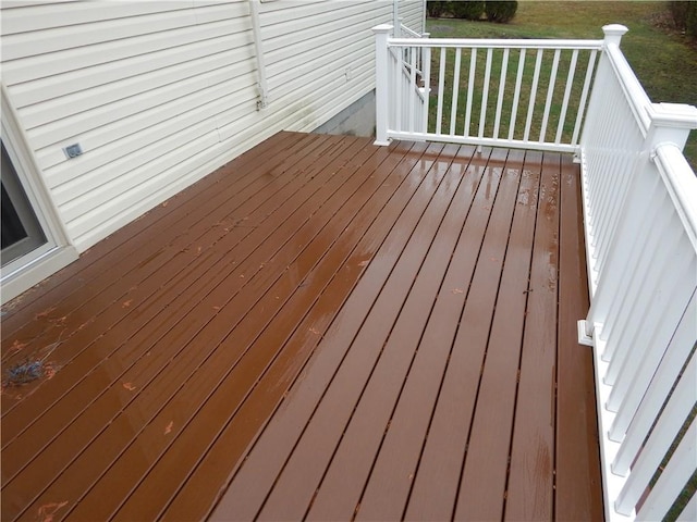 wooden deck featuring a lawn