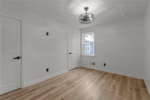 1212 James St, Central North Side, PA 15212 - unfurnished dining area featuring a chandelier, baseboards, visible vents, and light wood finished floors