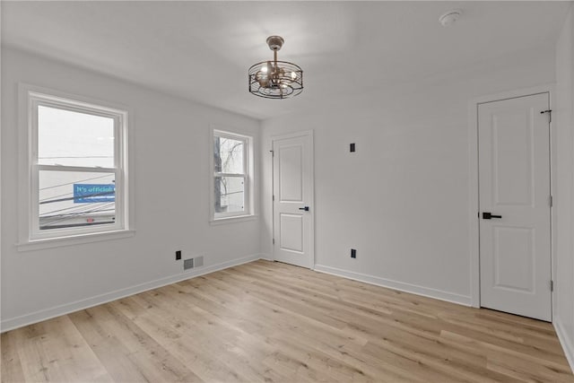1212 James St, Central North Side, PA 15212 - unfurnished dining area featuring baseboards, light wood finished floors, a notable chandelier, and visible vents