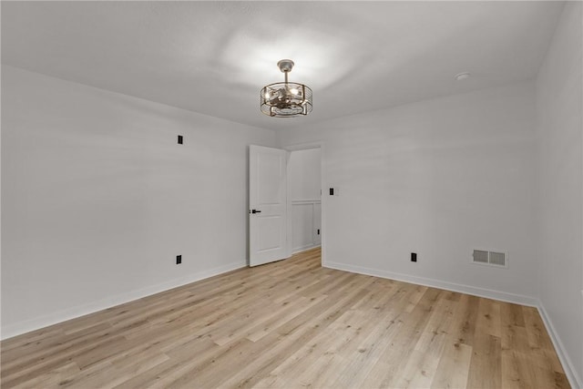 1212 James St, Central North Side, PA 15212 - spare room featuring visible vents, baseboards, light wood finished floors, and a notable chandelier