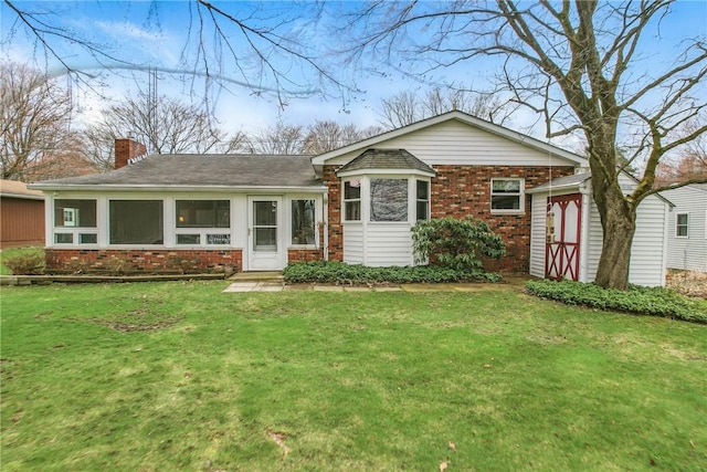7005 N Dr, Shenango-Cra, PA 16134 - view of front facade featuring brick siding, a front lawn, a chimney, and a sunroom