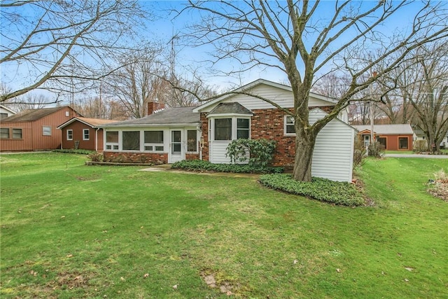 7005 N Dr, Shenango-Cra, PA 16134 - view of front of house with a front yard, a chimney, and a sunroom