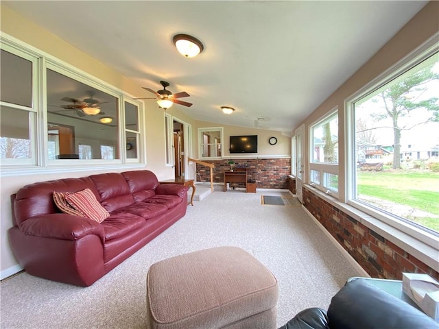 7005 N Dr, Shenango-Cra, PA 16134 - carpeted living area featuring brick wall, plenty of natural light, vaulted ceiling, ceiling fan, and baseboards