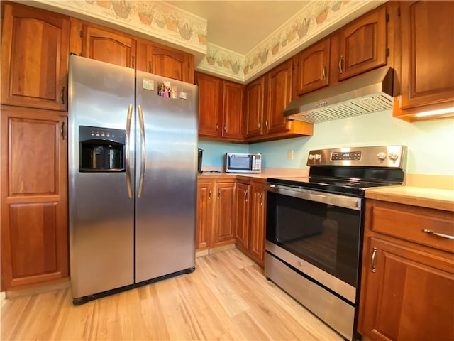 7005 N Dr, Shenango-Cra, PA 16134 - kitchen featuring stainless steel appliances, under cabinet range hood, light countertops, and light wood-type flooring