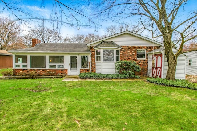 7005 N Dr, Shenango-Cra, PA 16134 - view of front of property featuring brick siding, a front lawn, a chimney, and a sunroom