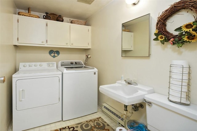 washroom with independent washer and dryer, a baseboard radiator, cabinet space, and a sink