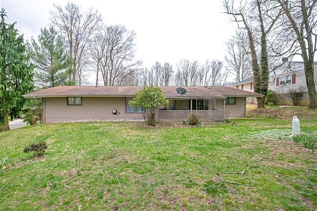 back of property featuring a yard