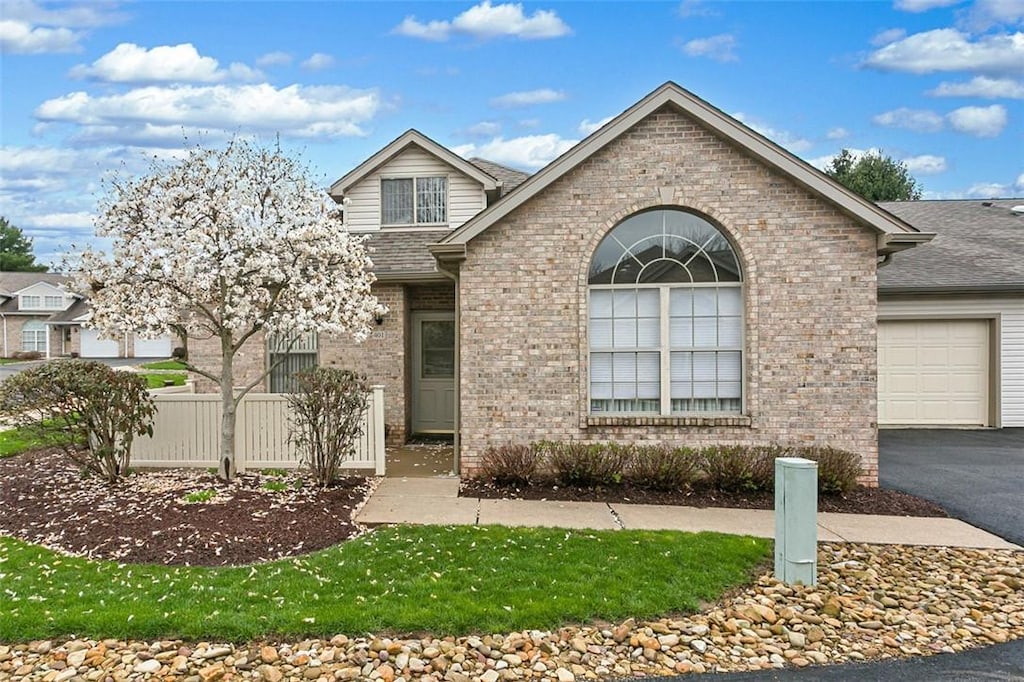 401 Malcolm Ct, Monroeville, PA 15146 - view of front of home with aphalt driveway, fence, a garage, brick siding, and roof with shingles