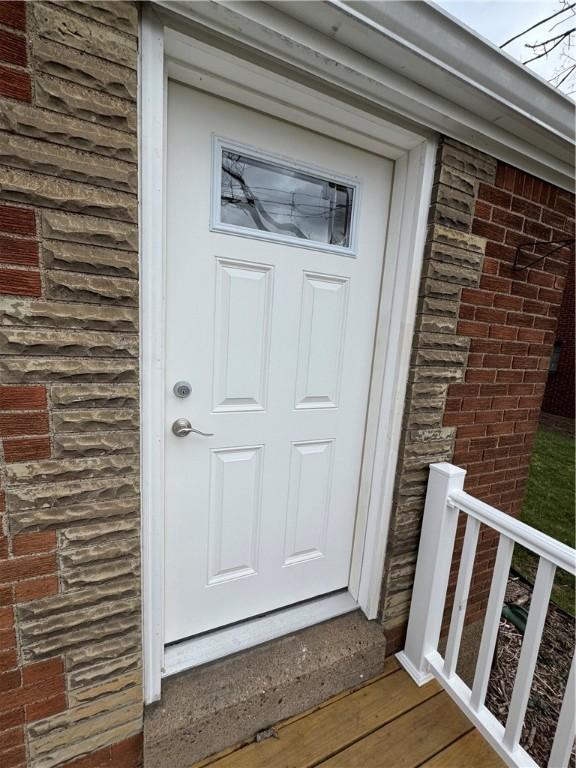 property entrance featuring brick siding