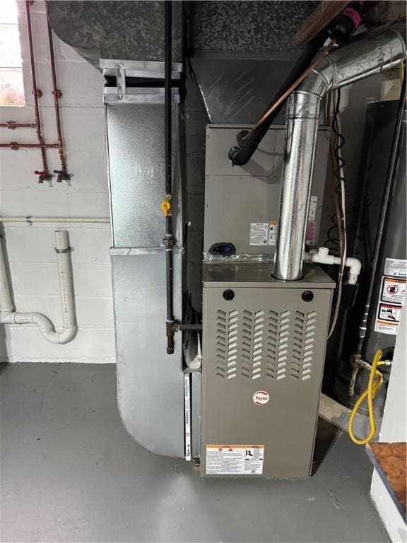 utility room featuring heating unit