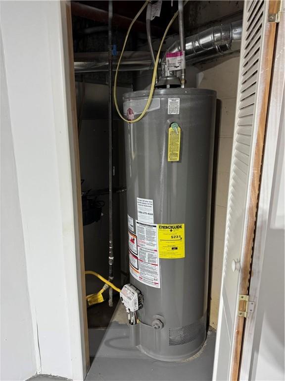 utility room with gas water heater