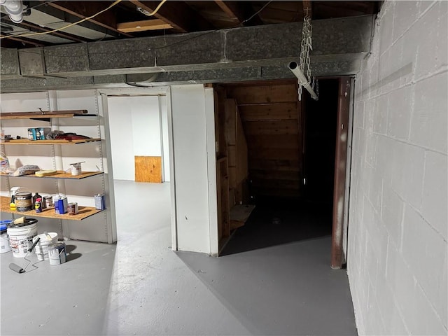 unfinished basement with concrete block wall