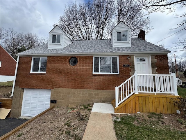 view of front of house with a chimney, an attached garage, brick siding, and roof with shingles