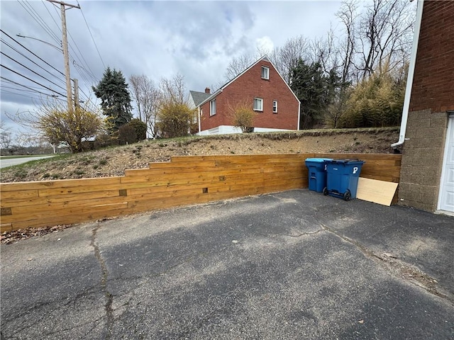 exterior space with driveway and fence