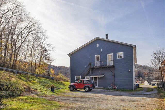 rear view of property with driveway