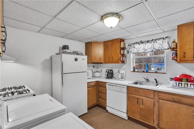kitchen featuring white appliances, brown cabinets, a sink, and open shelves