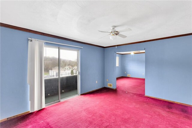 empty room featuring carpet flooring, a ceiling fan, ornamental molding, and visible vents