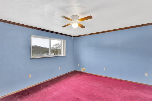 carpeted spare room with crown molding, a textured ceiling, baseboards, visible vents, and ceiling fan