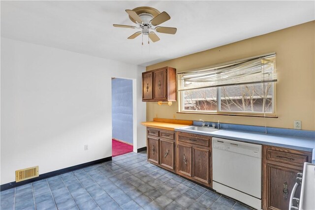 kitchen featuring light countertops, a sink, white dishwasher, visible vents, and ceiling fan
